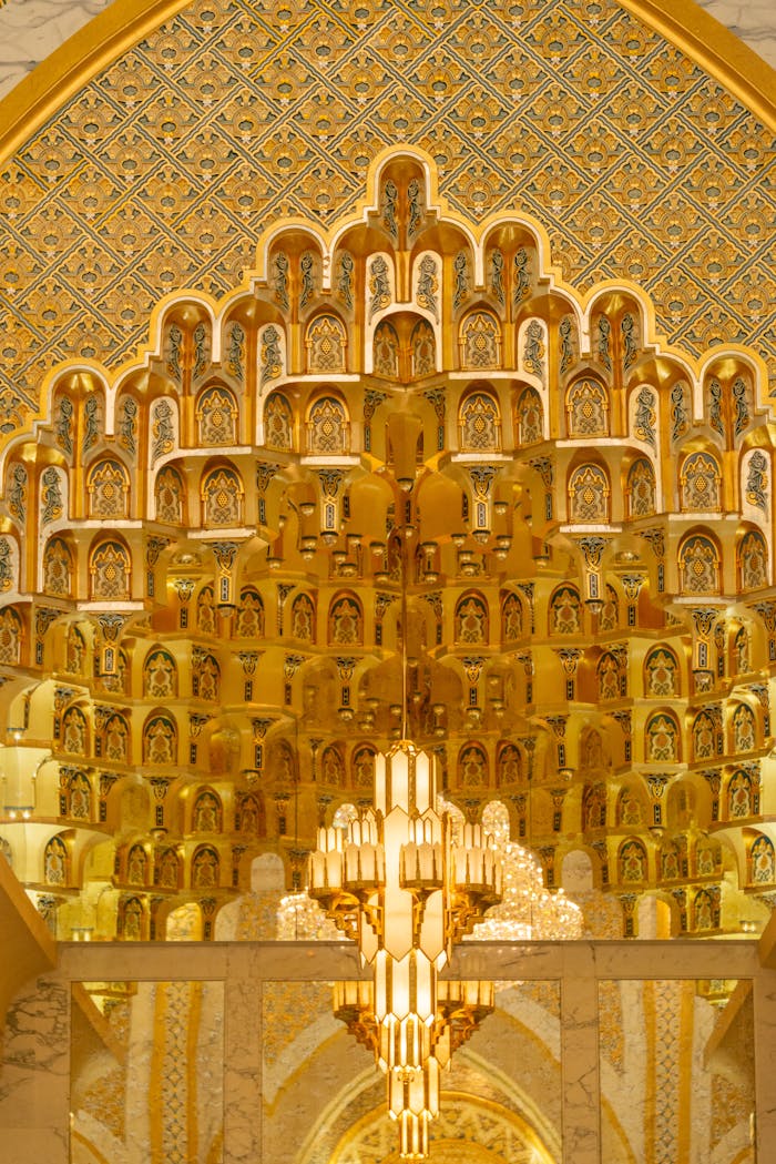Stunning architectural golden ceiling with intricate details and luxurious chandelier.