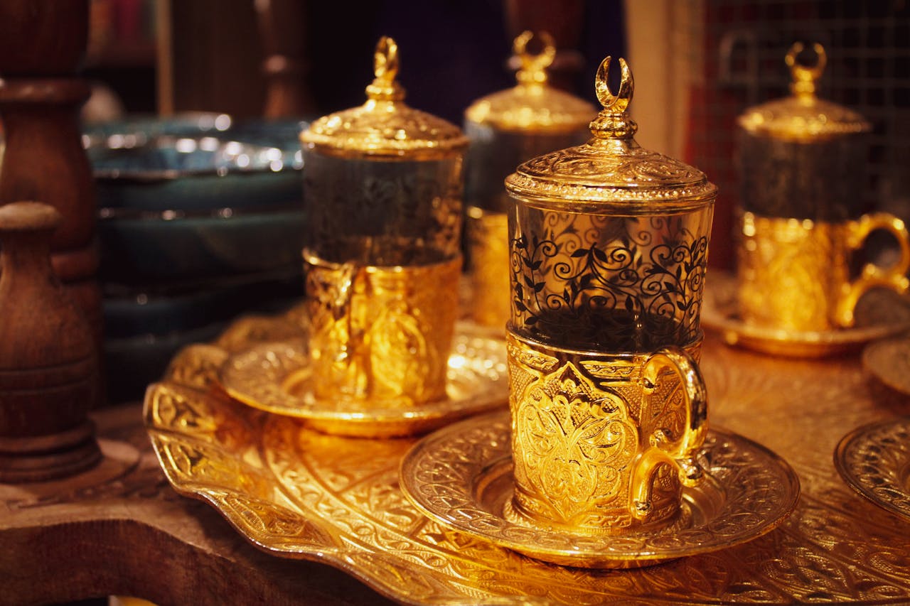Luxurious gold tea set with intricate designs on a decorative tray, Doha.